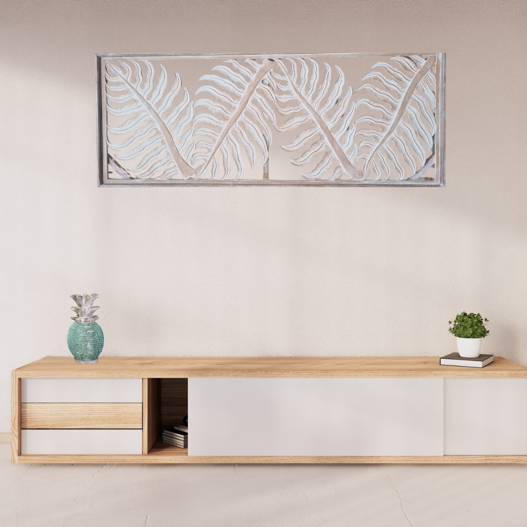 Tropical fern leaf wall hanging in natural wash finish displayed vertically in a modern entryway, with horizontal display visible through archway