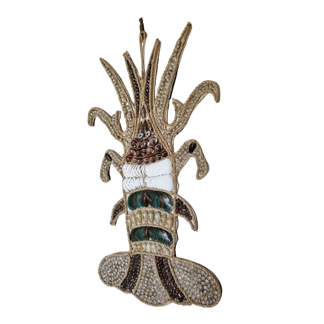 Angled side view of handcrafted sculpture showing layered shell body detail, curved tendrils and textured jute rope base