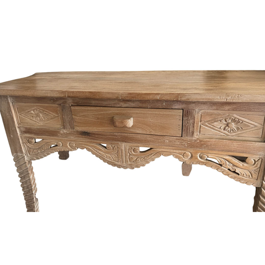 The table - close up of Balinese artisan carved diamond panels, floral motifs and scrolled apron