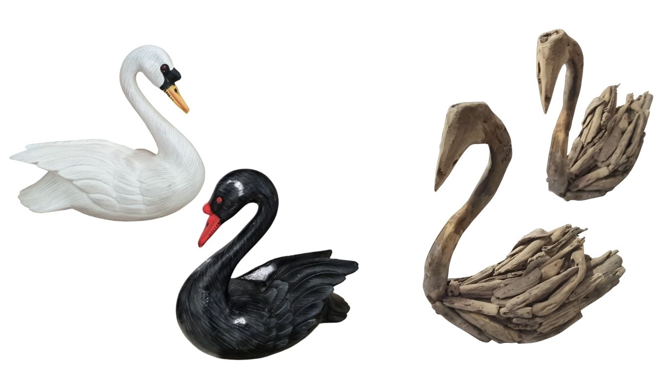 Four swan figurines in different styles on a white background