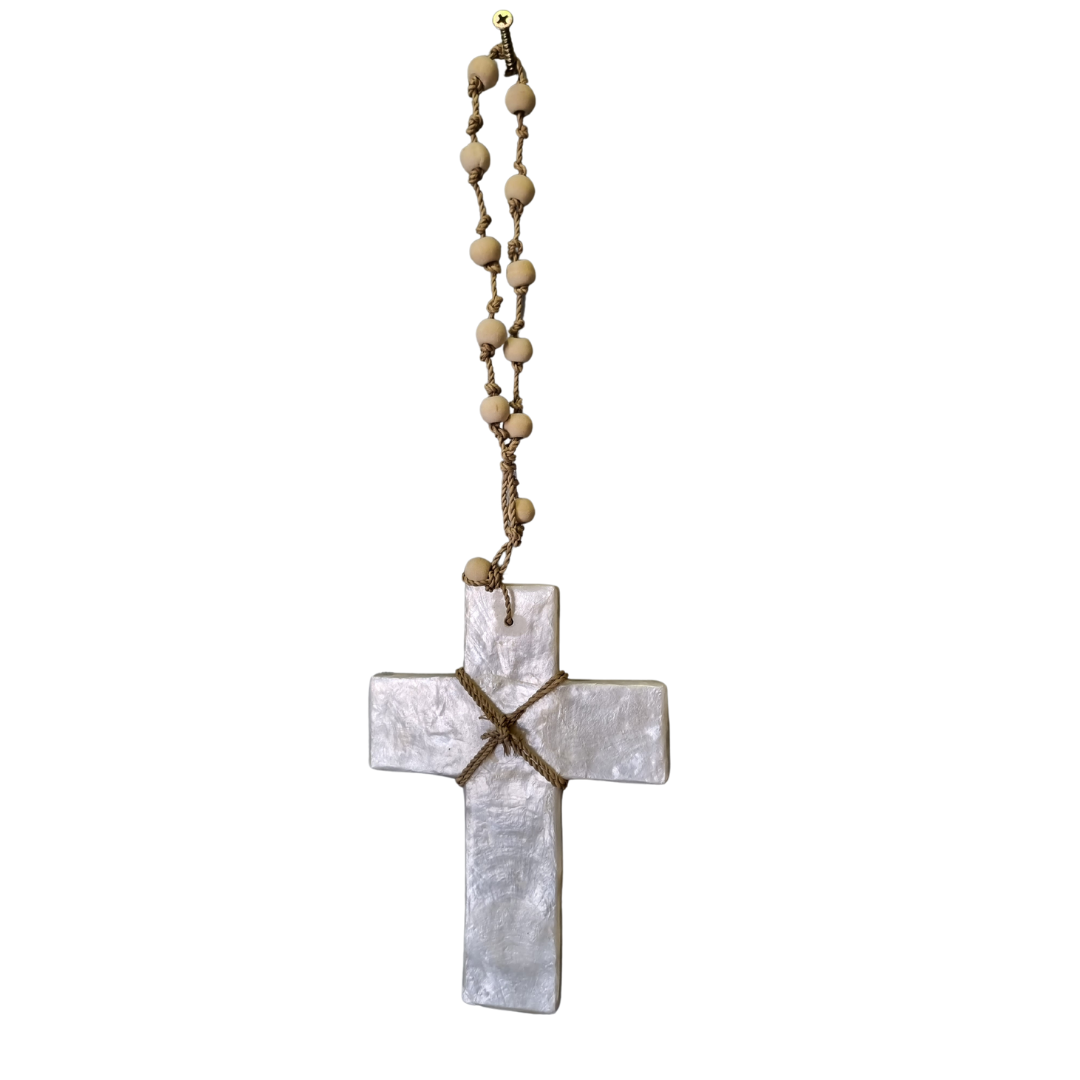 Handcrafted White Cross made from Capiz Shell with a brown cord centre and wooden beaded hanger on a white background.