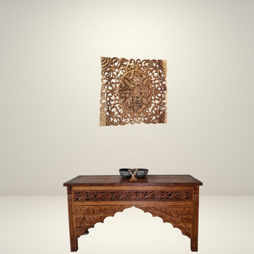 A Balinese carved wall art panel featuring a floral design, made from suar wood.