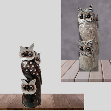 Set of owl-shaped decorative items on a wooden surface with a gray background.