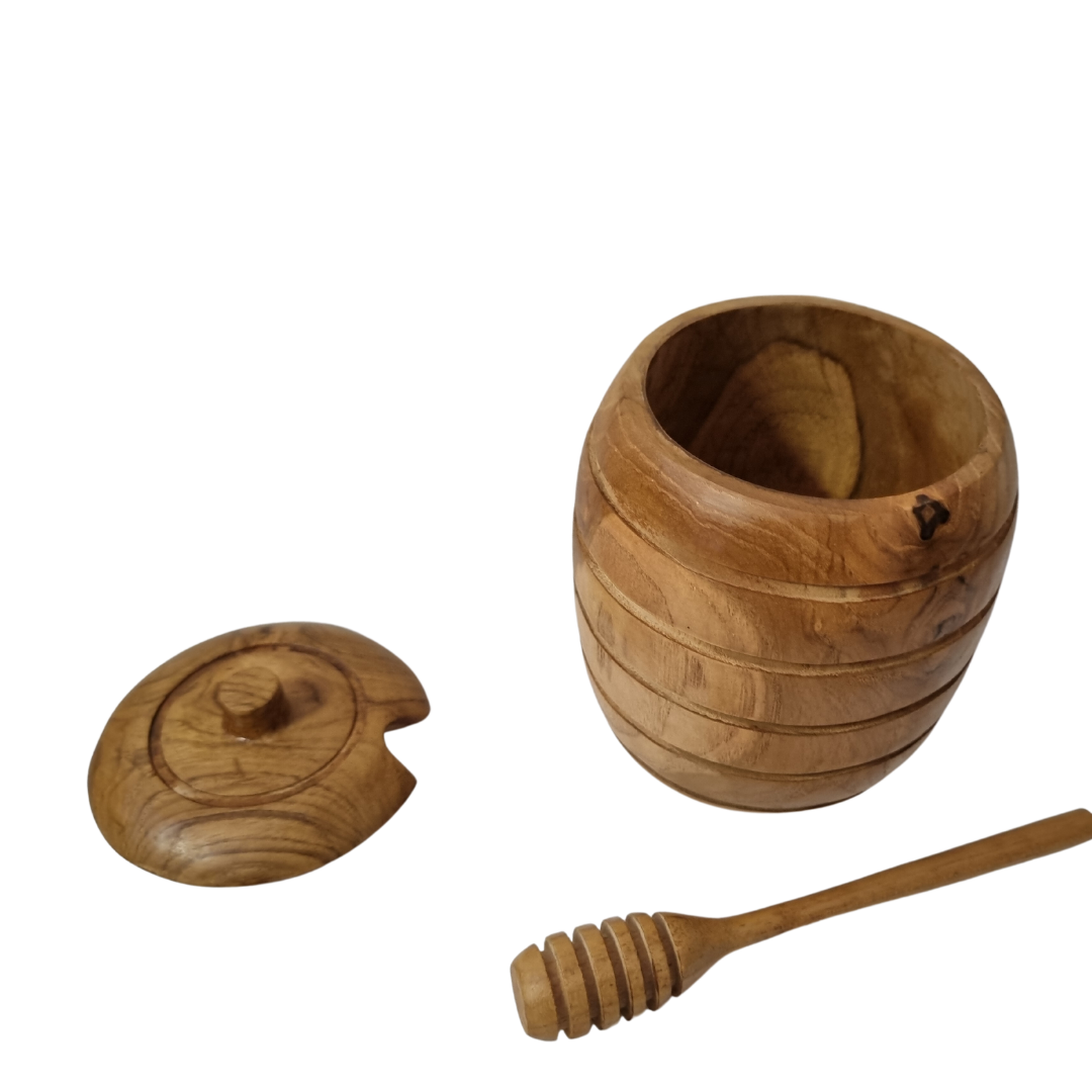 Open grooved timber container with its notched lid and ridged serving stick arranged beside it