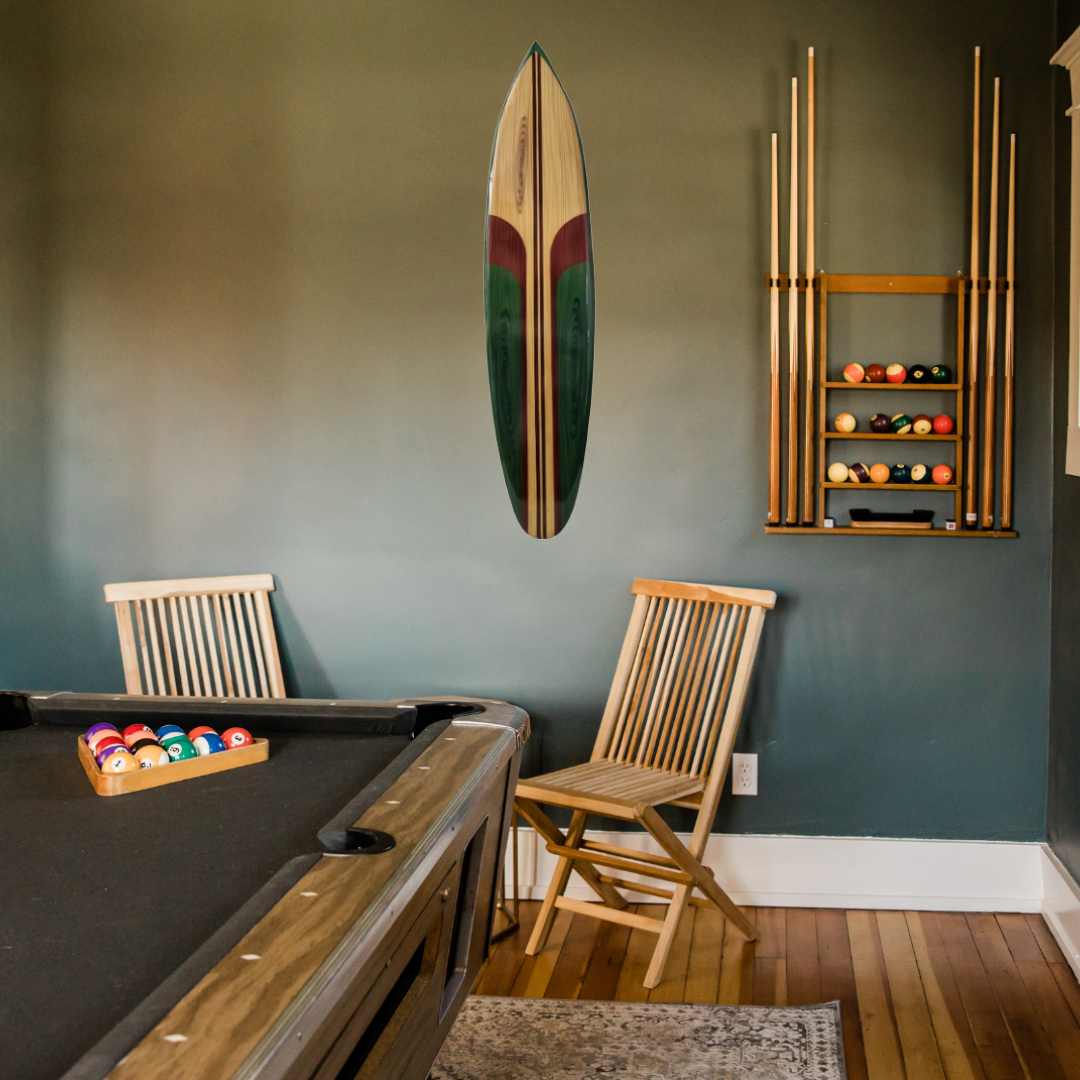 Wooden surfboard wall art in green and natural wood tones hung above a pool table in a games room – coastal wall decor | Azure Decor