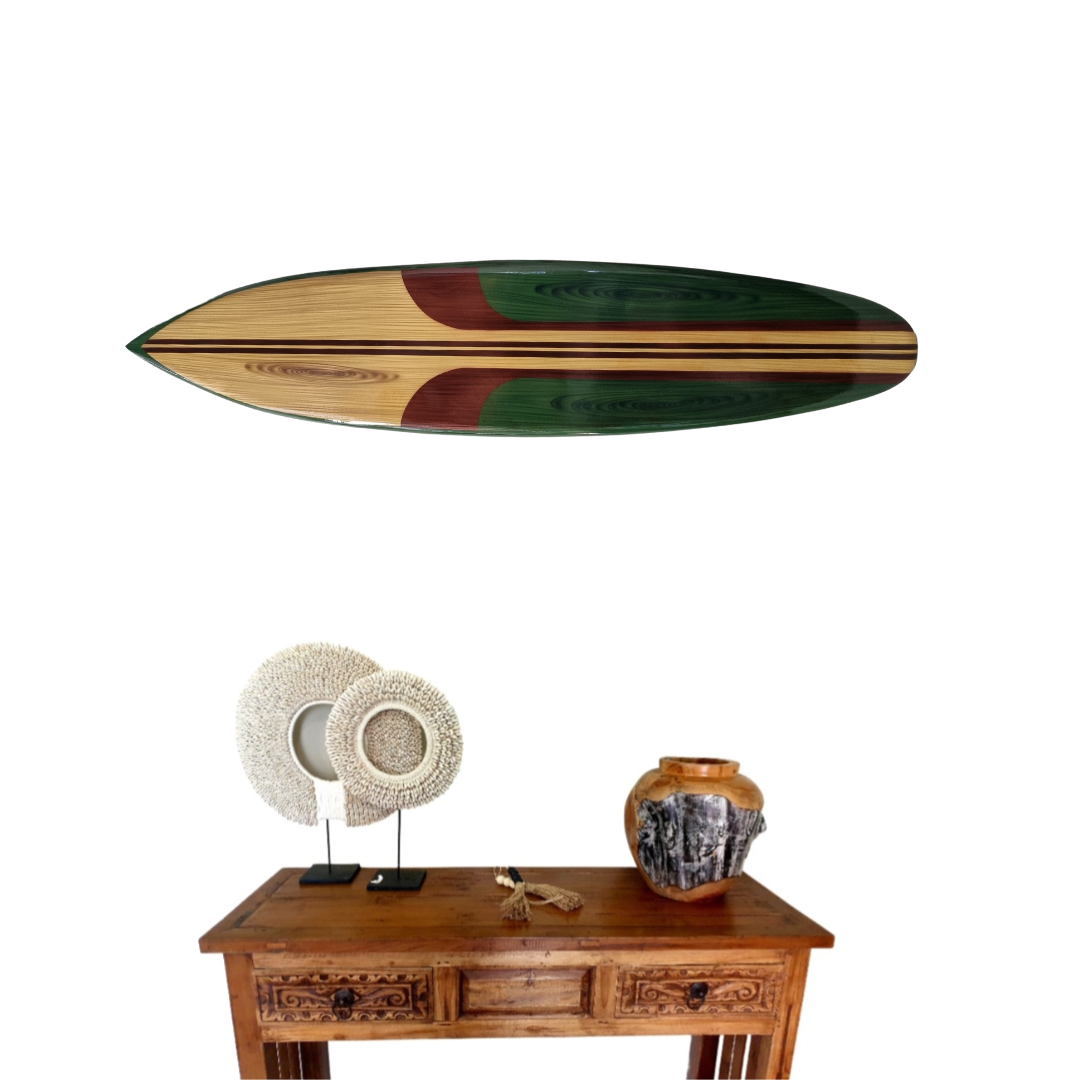 Wooden surfboard wall art in green hung horizontally above a carved timber console styled with shell discs and a stone vase – coastal home decor | Azure Decor