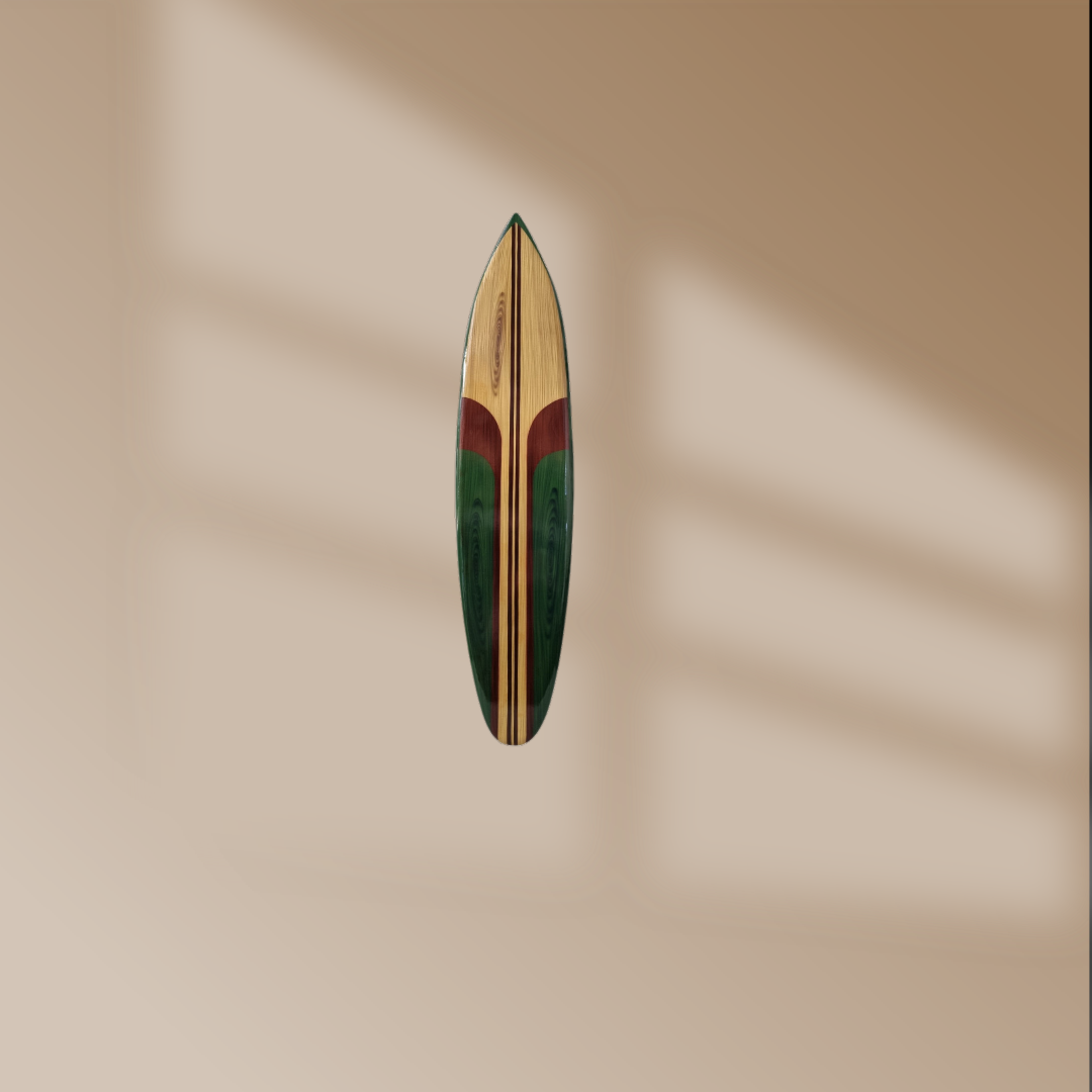 Wooden surfboard wall art in green and natural wood tones against a warm sandy wall with soft natural light shadows – coastal wall decor | Azure Decor