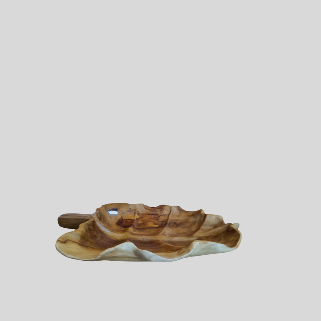 Wooden leaf-shaped object on a light gray background