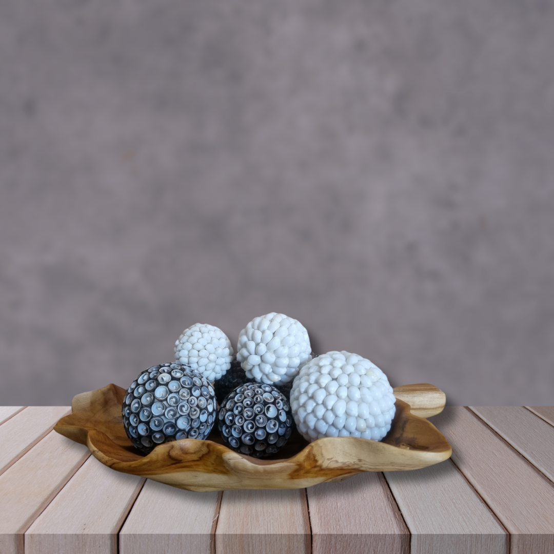 Woode leaf tray with beautiful shell balls resting on the tray rustic gray backround with wooden shelf