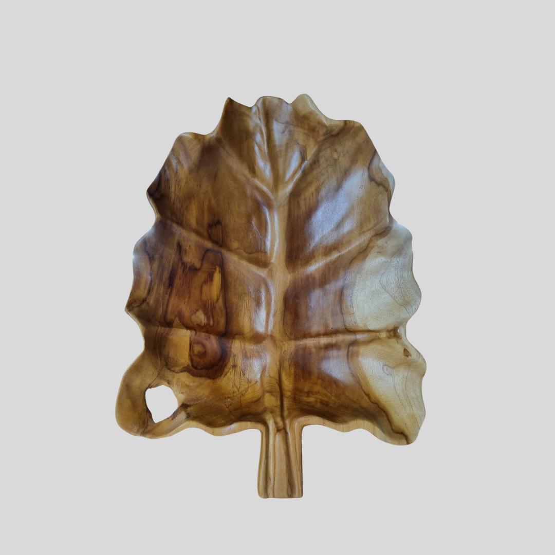 Wooden leaf-shaped tray on a light gray background