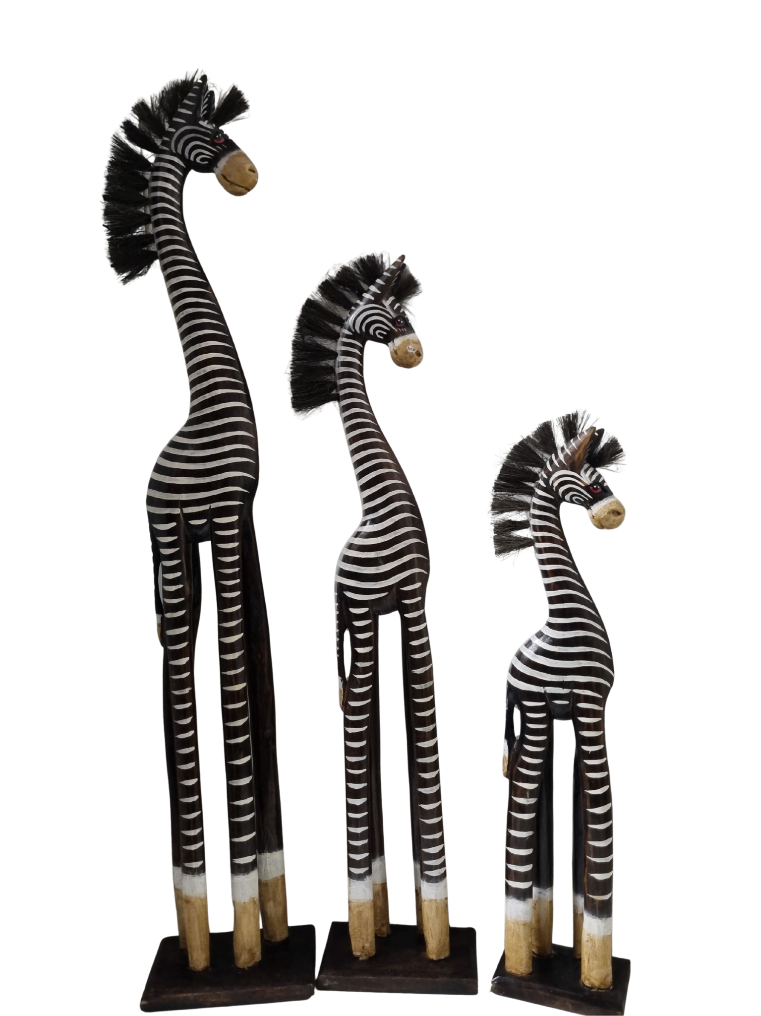 Three zebra figurines of different heights on a white background