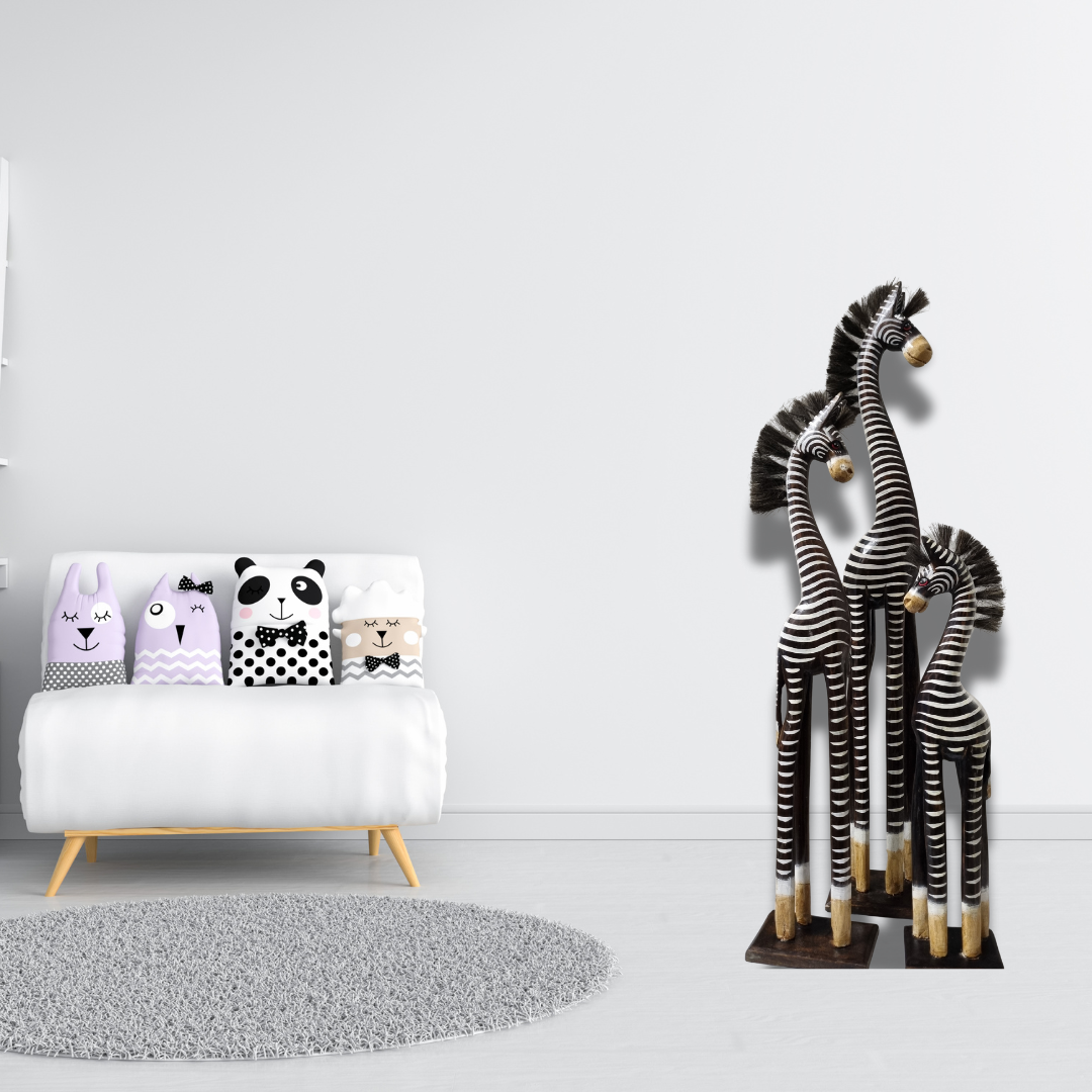 Decorative giraffes and animal-themed pillows on a white couch in a minimalistic room.