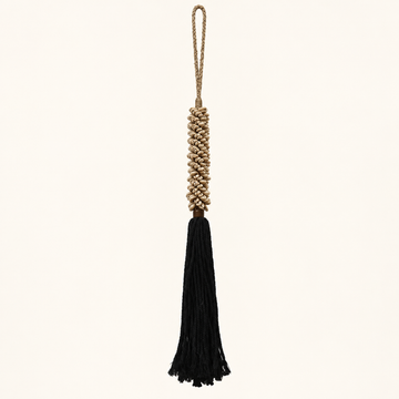Cowrie shell decorative tassel tieback with black cotton fringe on a light background
