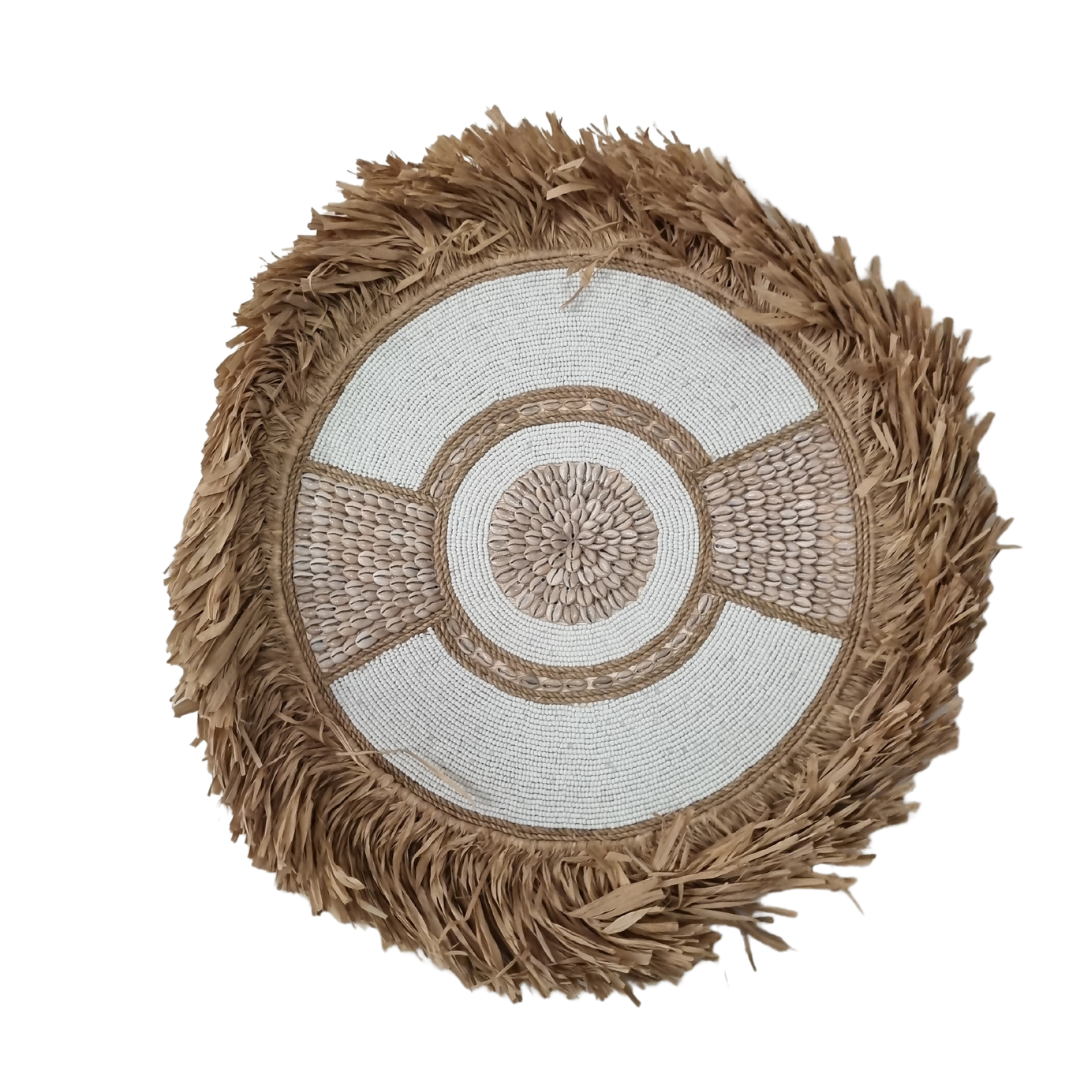 Three circular boho style wall art pieces made of seagrass with beads and shells, in natural beige and white colors, displayed against a white background.