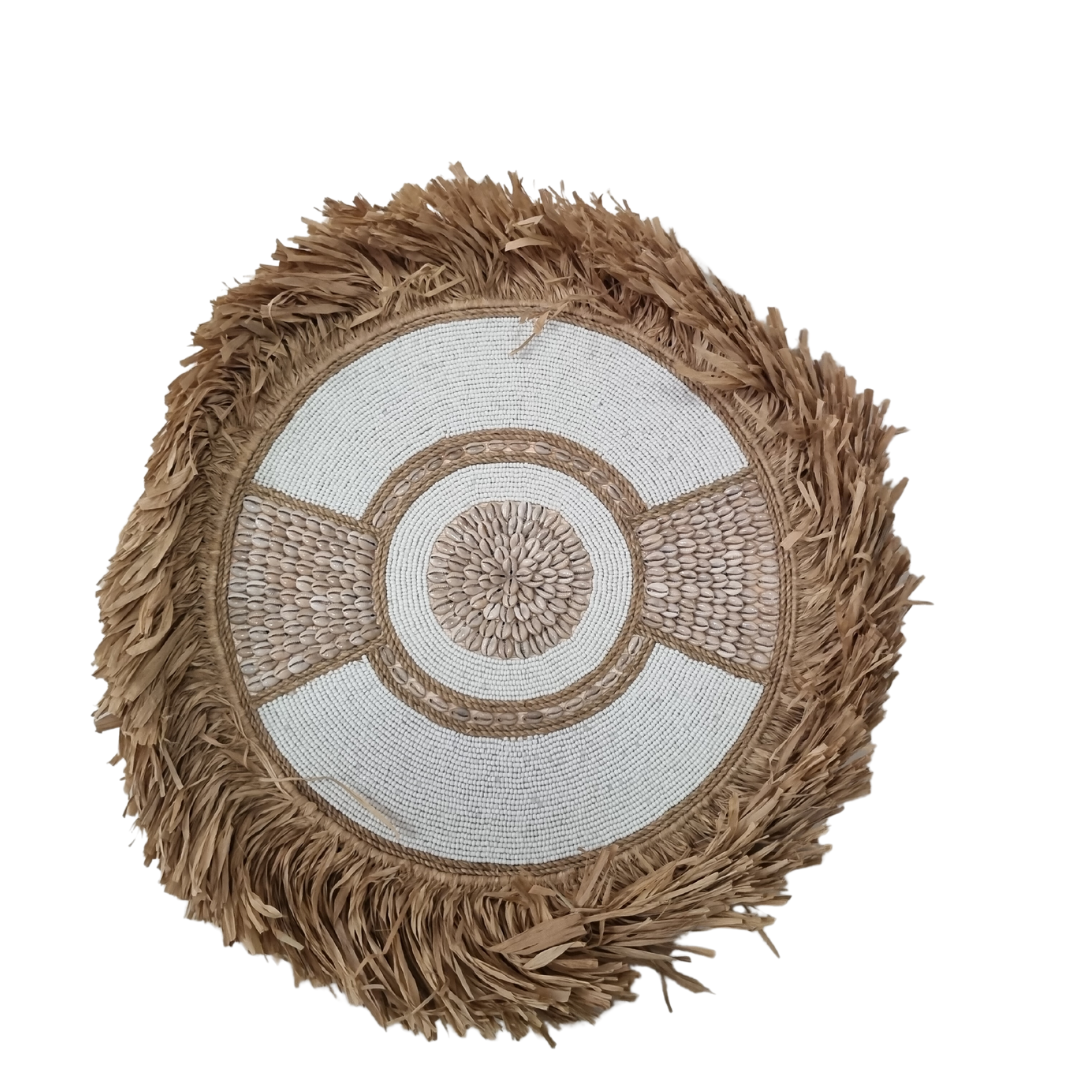 circular boho style wall art pieces made of seagrass with beads and shells, in natural beige and white colors, displayed against a white background.
