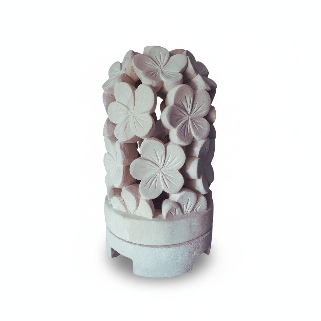 A decorative white stone garden sculpture featuring a cluster of carved  flowers on a tiered base, set against a plain white background.