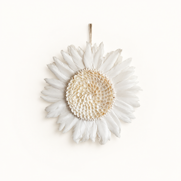 Juju Hat White Design with layered white feathers and a textured shell centre on a pale background