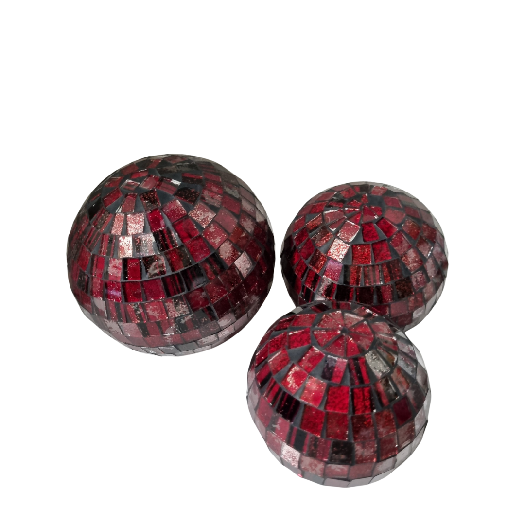 Three red mosaic decorative balls with a geometric glass tile pattern on a white background