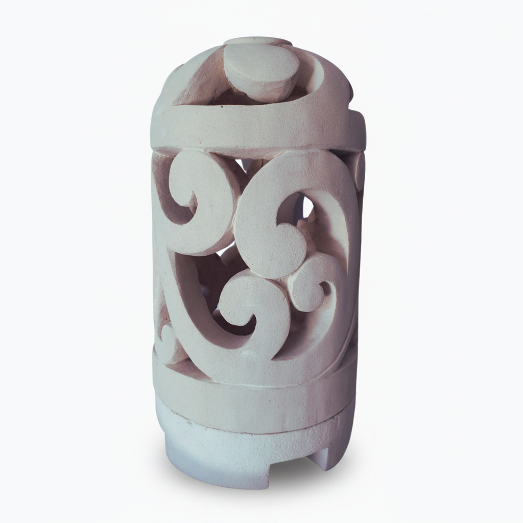 A cylindrical decorative object with a carved scrollwork pattern, shown on a plain white background.
