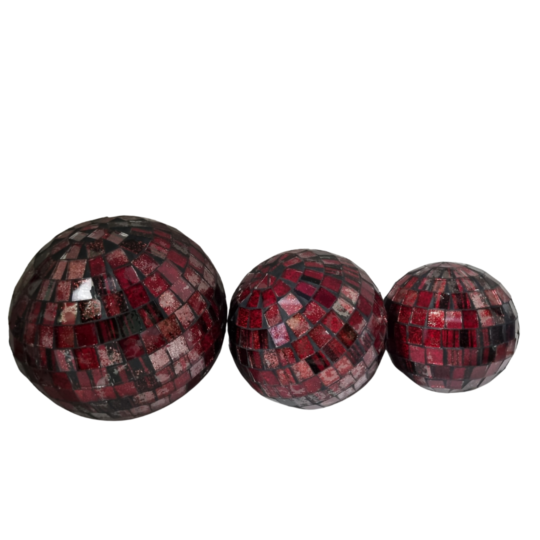 Three red mosaic glass spheres in large, medium and small sizes on a white background