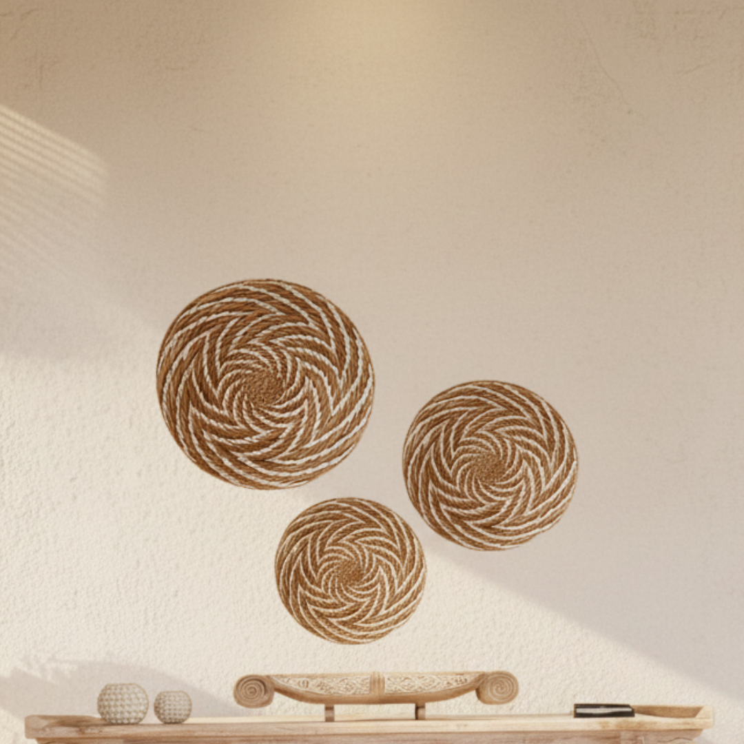 3 arrrange wall decorations set aboe a cabinet with 2 shell tealight holders and a boat style tray.