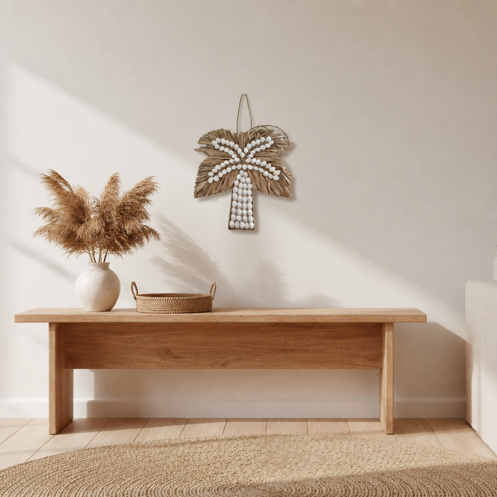 Small white shell and seagrass decoration displayed above a timber console in a coastal living room, 21 × 21 cm