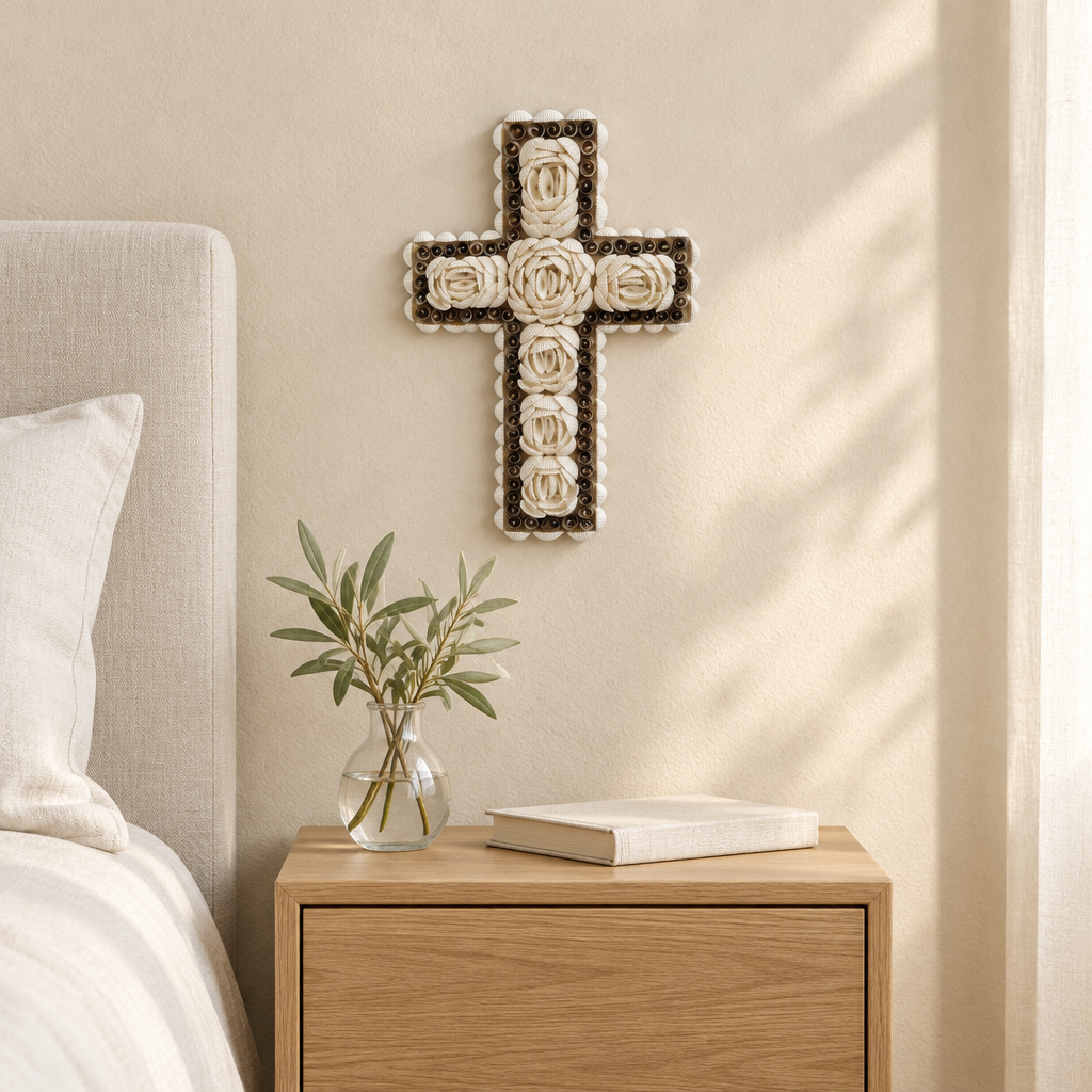 White rosette decoration above an oak bedside cabinet with a glass vase, leafy stems and a book.