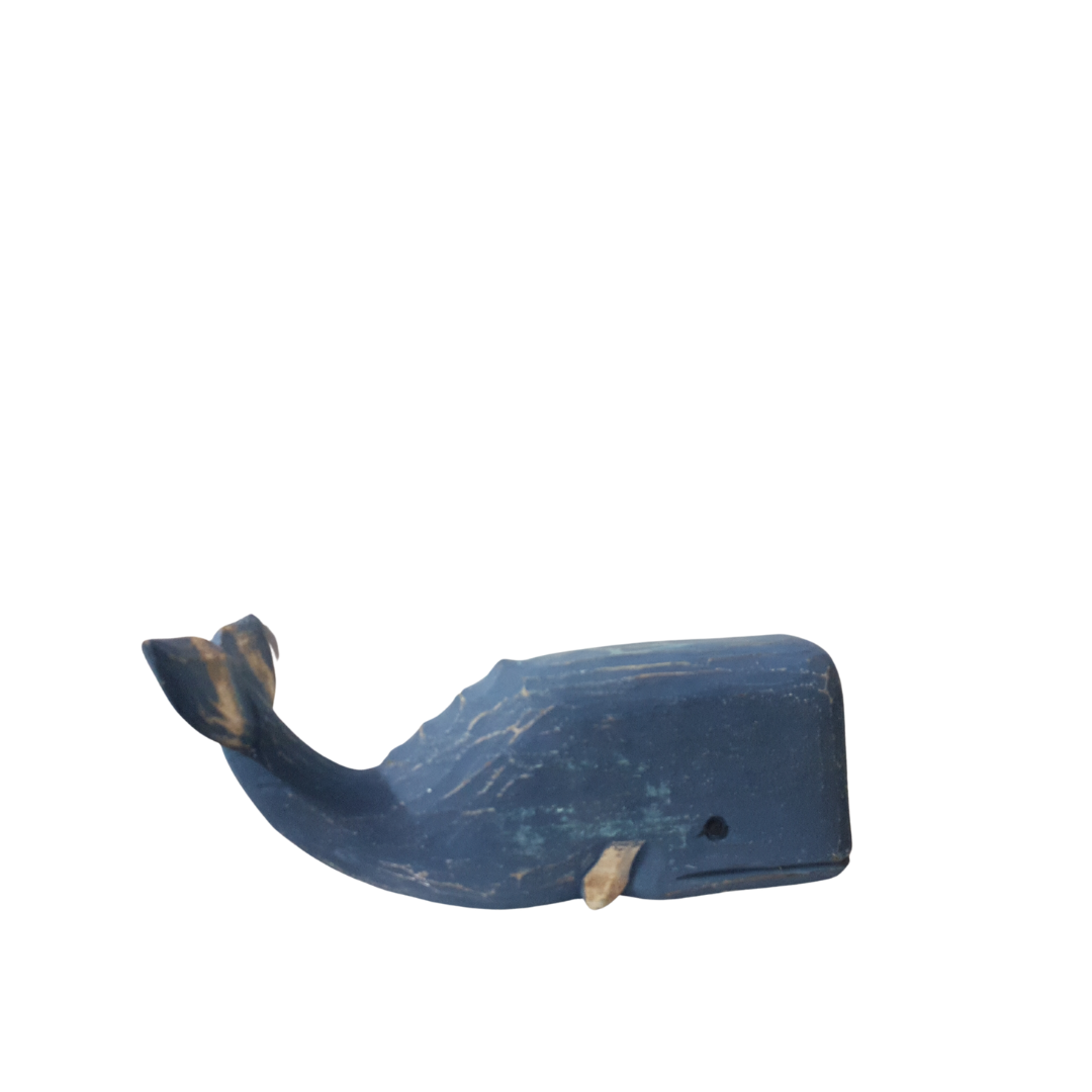 A wooden carved whale decoration in blue color with a rustic finish.