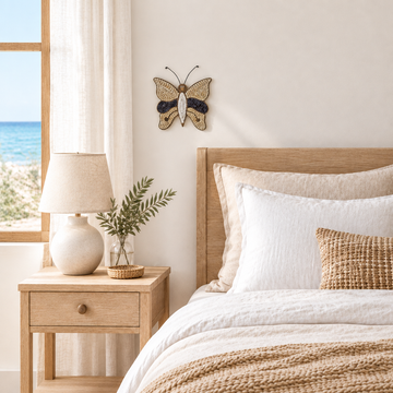 30 cm x 29 cm handmade winged decoration above a linen bed in a coastal guest room