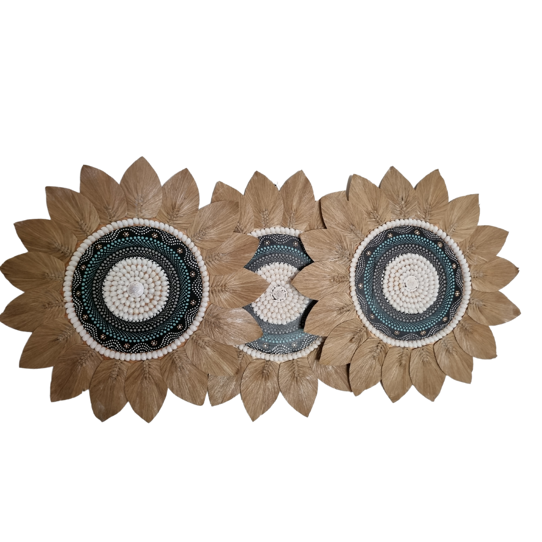 Three Tropical style shell and seagrass wall decoration with painted centrepiece on a white wall 