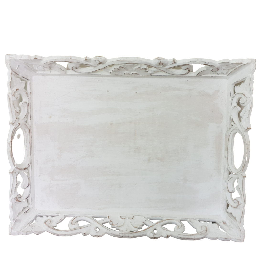 Top-down view of small Balinese whitewash carved wooden tray showing ornate scrollwork edge carving and oval handles