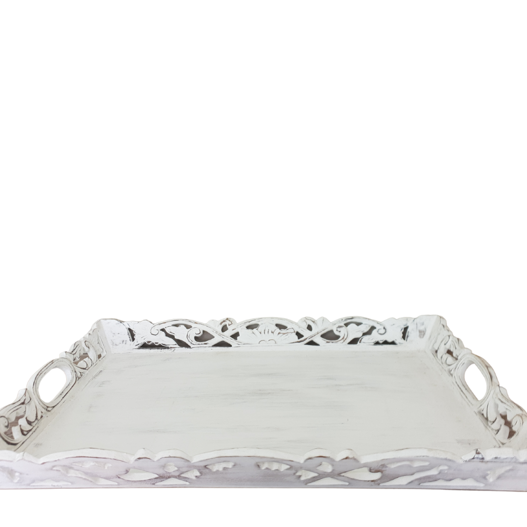 Side profile of Balinese whitewash carved wooden tray showing ornate scrollwork edge detail and oval carry handles