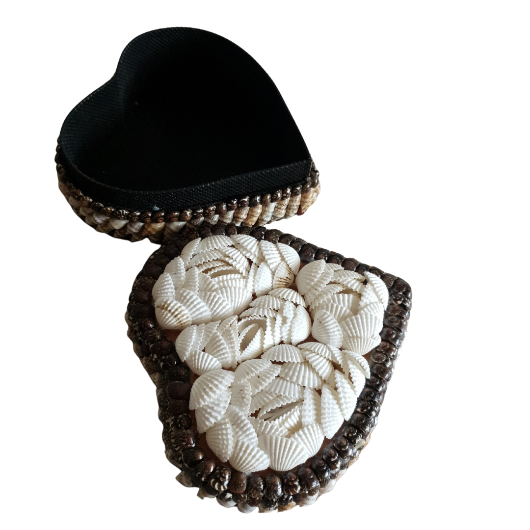 heart shaped trinket box with a black interior and a white shell opened 