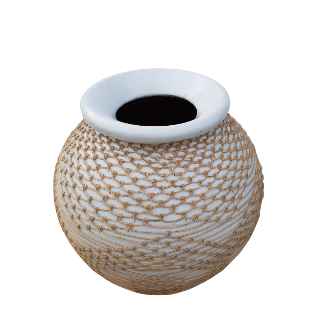 Globe-shaped white vase with knotted natural rope net wrap styled on a white background